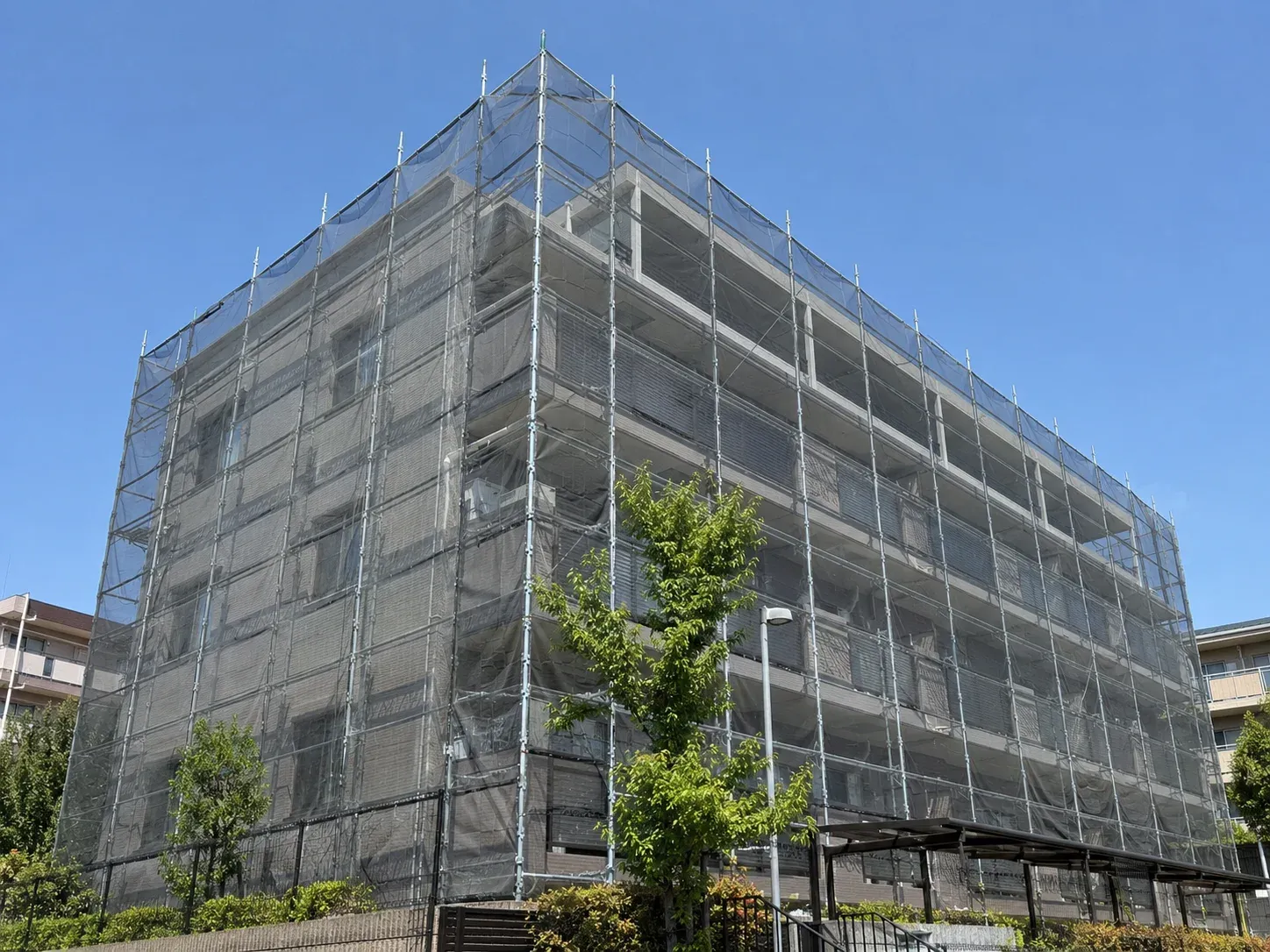 足場とメッシュシートで覆われた集合住宅の外壁改修（イメージ）